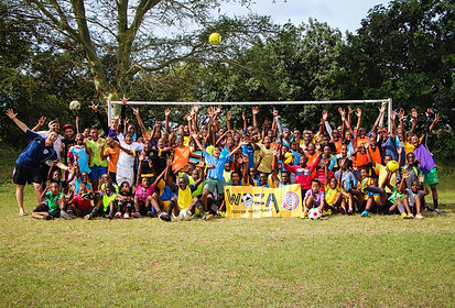 South African boys soccer team celebrating with Chris Kaimmer. Beginnings of Woza soccer and building and supporting community though soccer and service.