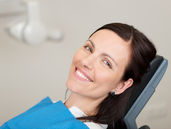 A young woman smiling at the dentist clinic