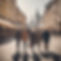 Two people in their 50s and three people in their 40s walking through a big European city.
