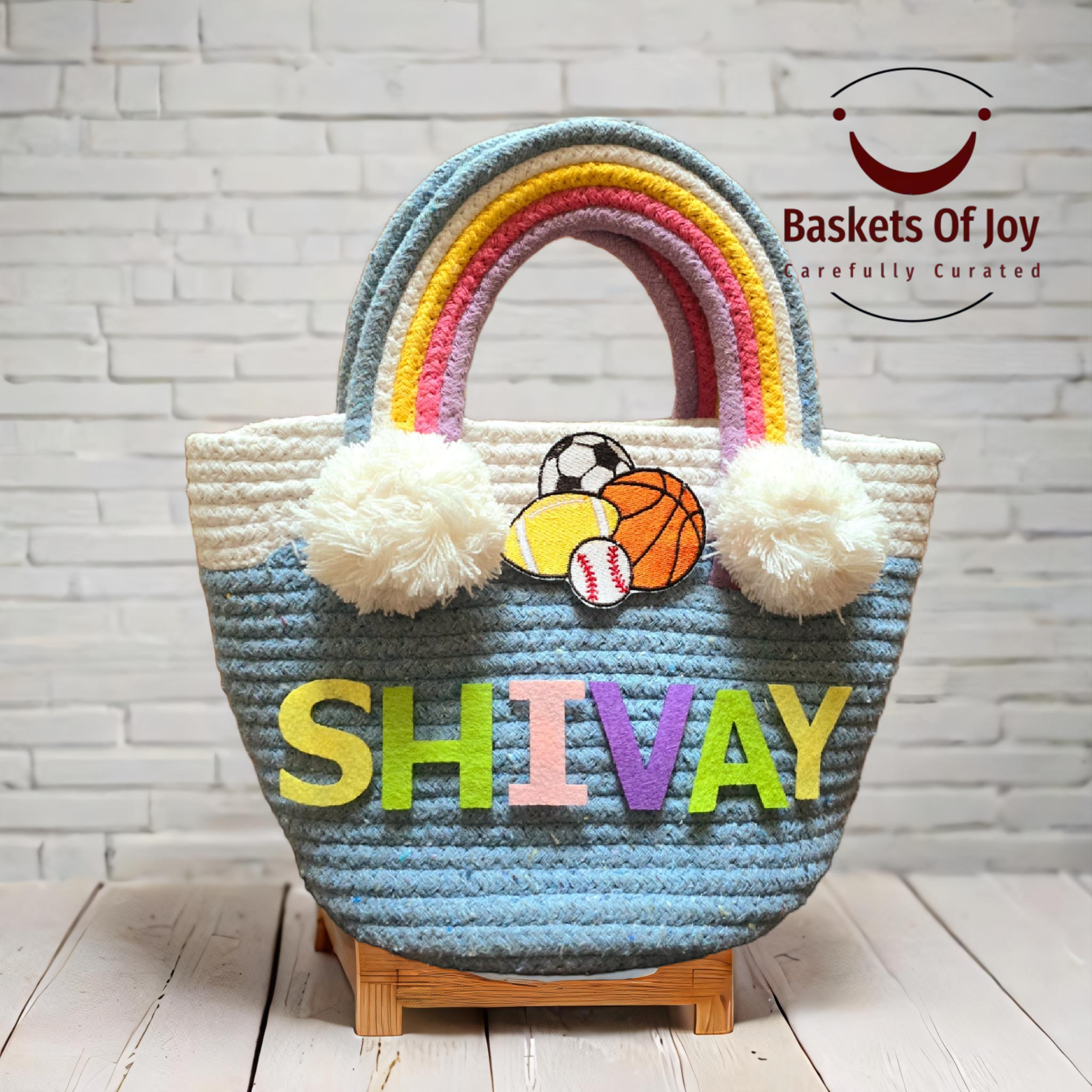 Rainbow tote bag with SHIVAY name, sports balls, and pom-poms