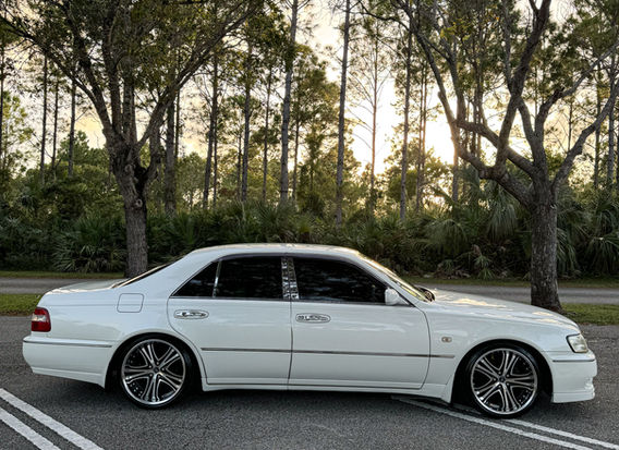 1997 Nissan Cima Turbo for sale at Lion JDM, showcasing a sophisticated black exterior, luxury sedan design, and powerful turbocharged engine. The car features sleek lines, premium alloy wheels, and a comfortable, well-appointed interior. Available for purchase, this rare model combines performance and elegance, making it a standout choice for collectors and driving enthusiasts.