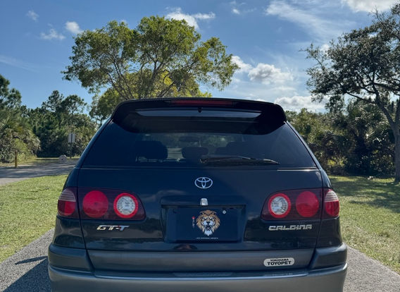1998 Toyota Caldina GT-T for sale – Turbocharged AWD JDM wagon with alloy wheels and aerodynamic design.