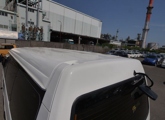Rear angle of a 1994 Mitsubishi Delica Star Wagon 4x4 featuring tow hitch, lifted chassis, and off-road upgrades – perfect for towing or vanlife conversions.