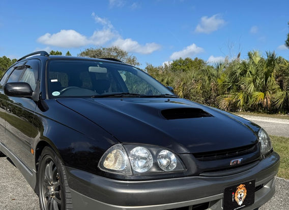 1998 Toyota Caldina GT-T for sale – Turbocharged AWD JDM wagon with alloy wheels and aerodynamic design.