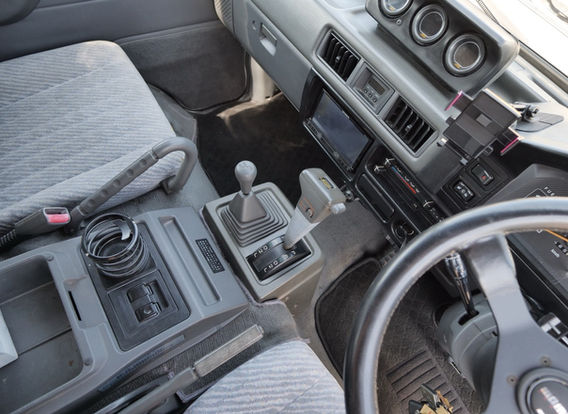 Interior dashboard of the Mitsubishi Delica 1994 diesel 4WD van, showing automatic transmission, air conditioning, power steering, and power windows – well-maintained Japanese import.