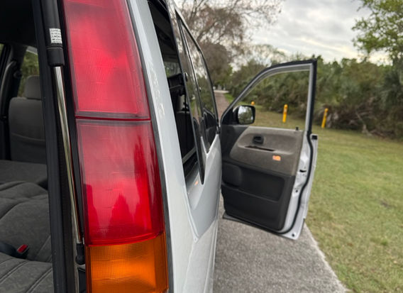 1998 Toyota LiteAce Noah 4WD side view featuring sliding doors, long wheelbase, and original JDM van profile