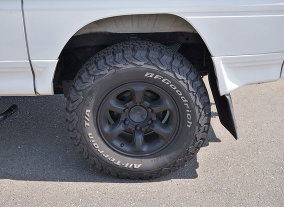 Rear angle of a 1994 Mitsubishi Delica Star Wagon 4x4 featuring tow hitch, lifted chassis, and off-road upgrades – perfect for towing or vanlife conversions.