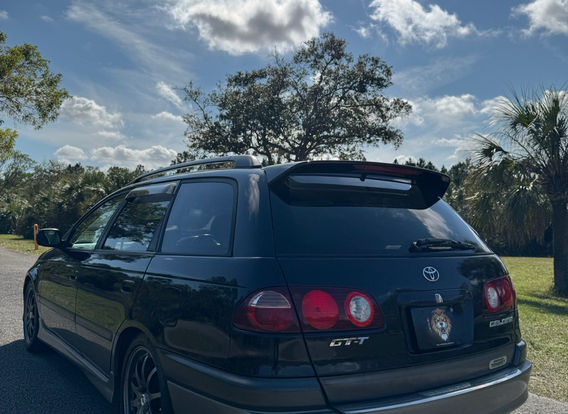 1998 Toyota Caldina GT-T for sale – Turbocharged AWD JDM wagon with alloy wheels and aerodynamic design.
