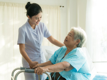 Young nurse supporting elderly patient