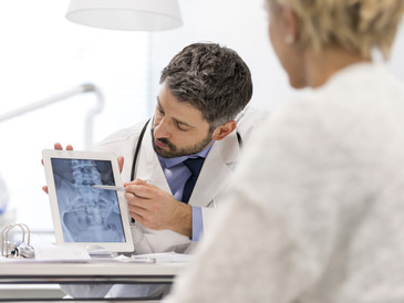 Doctor explaining X-ray to patient