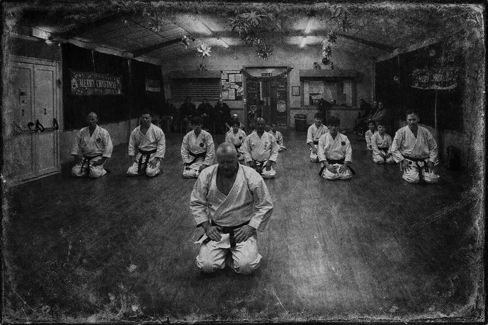 Karate practitioners in a vintage dojo.png