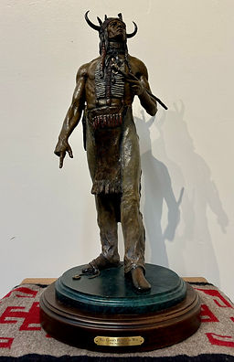 bronze sculpture  by Jeff wolf of an Indian chief with a pipe and fancy headress by Jeff Wolf