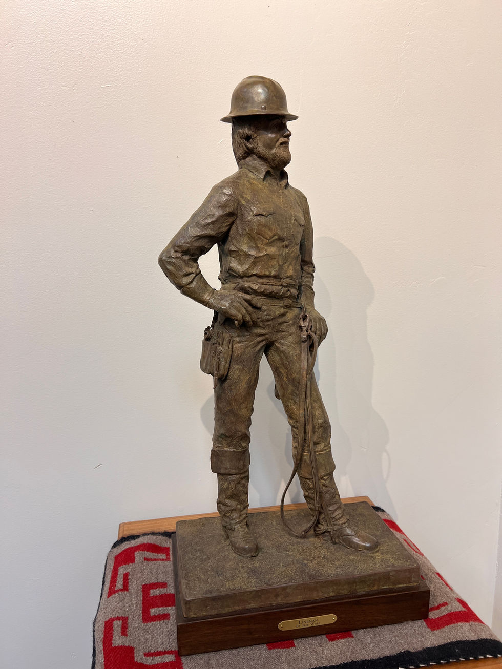 a bronze statue of a lineman wearing a hard hat, bronze sculpture, gold river gallery