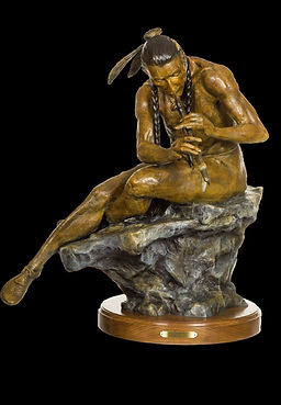 bronze sculpture by Jeff Wolf of an Indian sitting on a rock playing a flute at gold river gallery