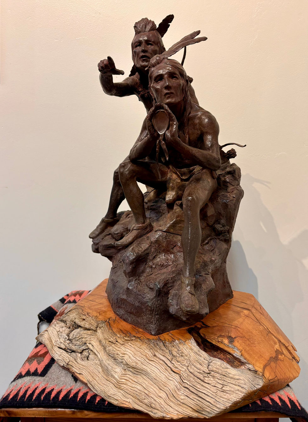 a bronze statue of two men sitting on a rock looking at a mirror, bronze sculpture, gold river gallery