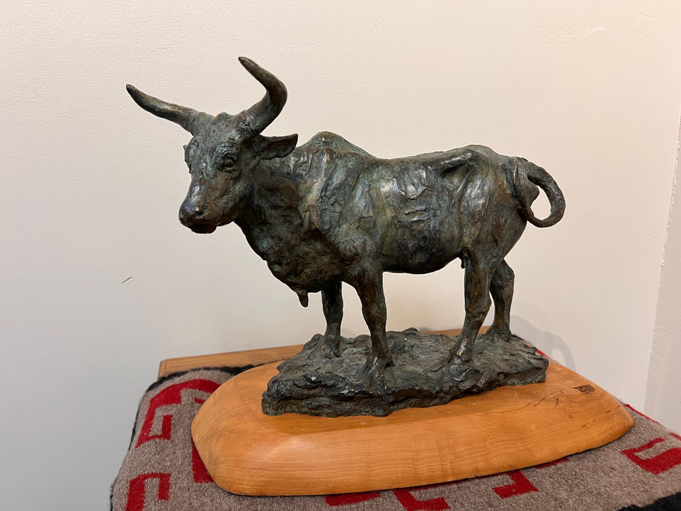 a statue of a longhorn bull standing on a wooden base, bronze sculpture, gold river gallery