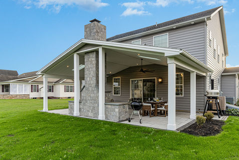 Covered outdoor patio with paver fireplace