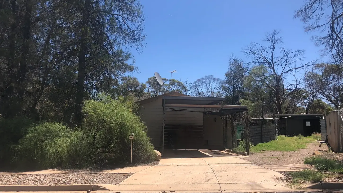 Front exterior of residential home in a natural rural setting