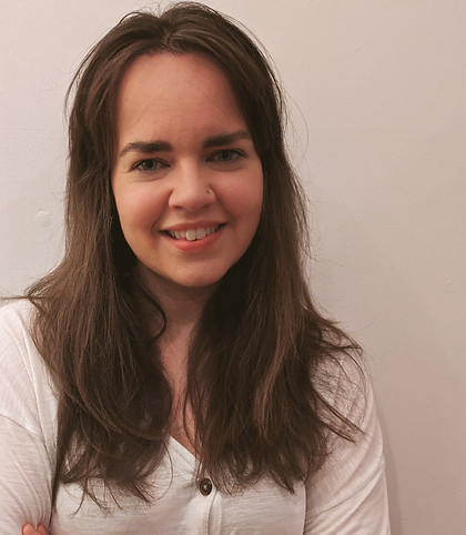 Image of Sarah looking at the camera, wearing a white shirt and smiling