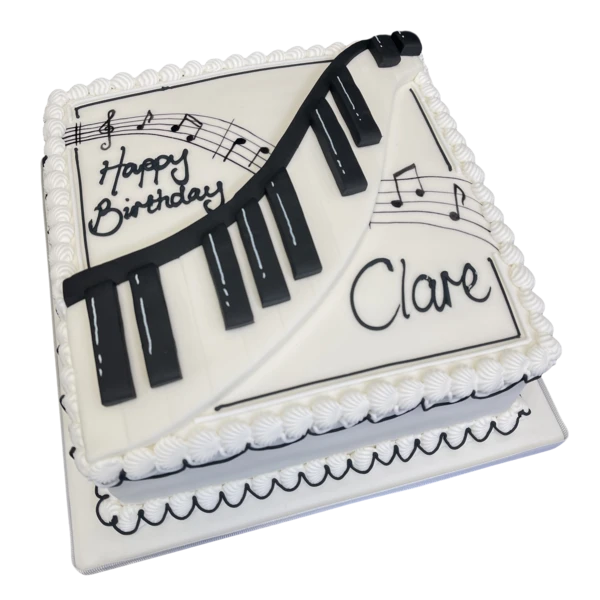 Bespoke celebration cake with piano keys and musical notes design in Solihull, West Midlands.