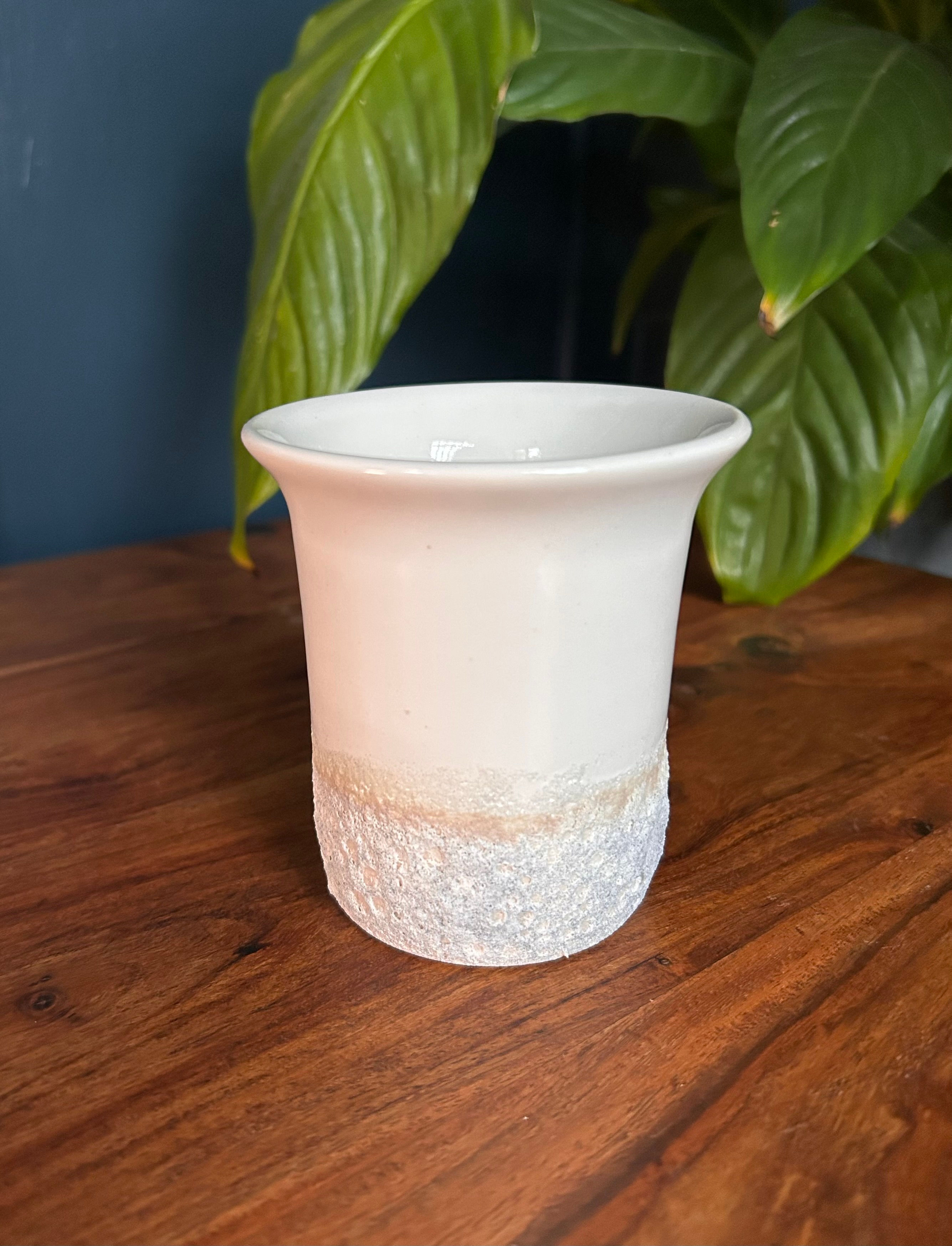 white bud vase side view on table