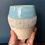 Thumbnail: hand holding blue and white textured vase front view