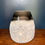 Thumbnail: small white and black bud vase on wooden shelf