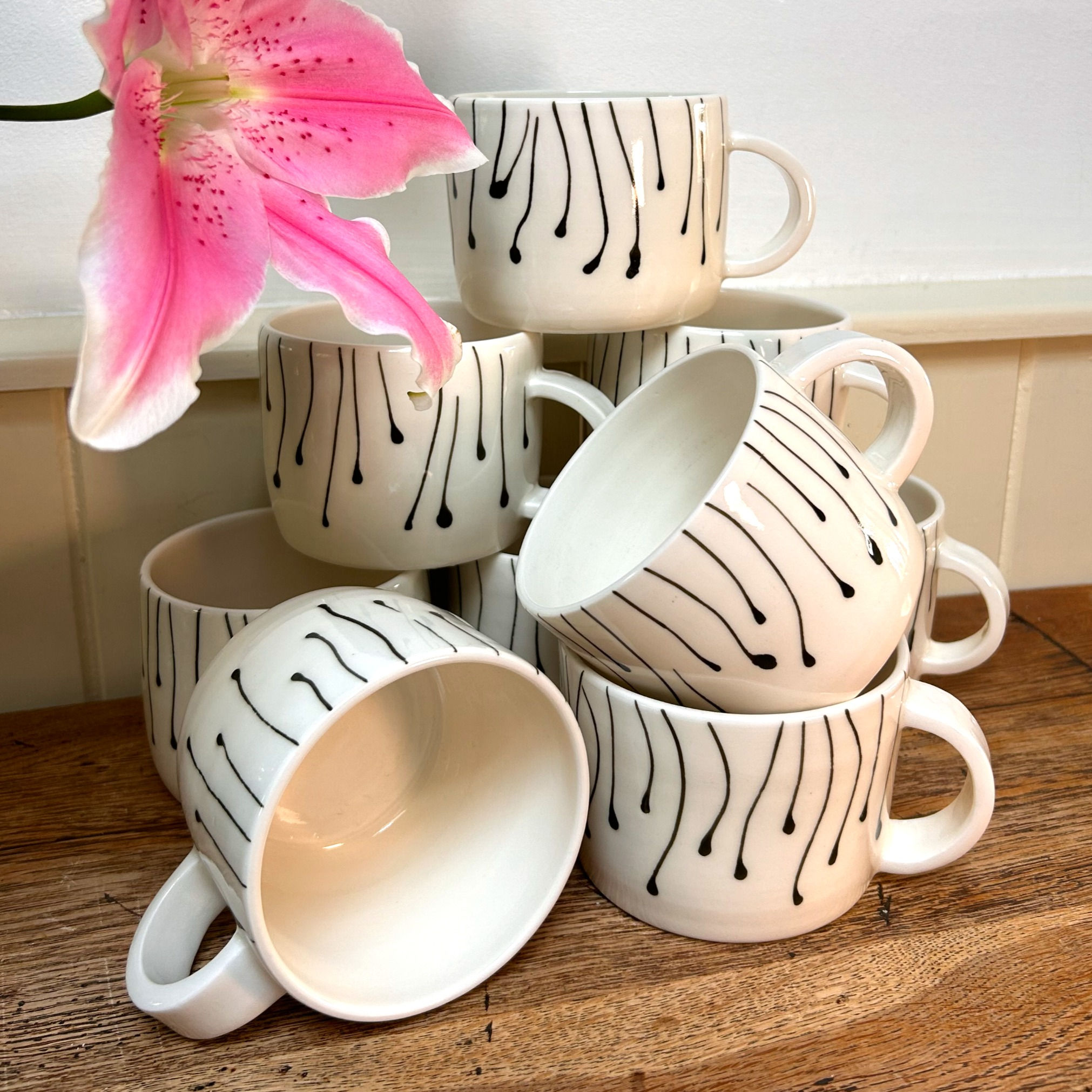 group of ceramic handmade mugs on table top