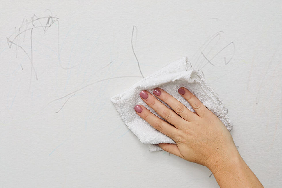 Wiping crayon marks off a white wall
