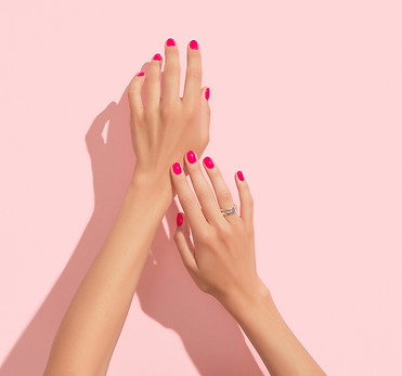 Womans hands with pink nail design. Manicure, pedicure beauty salon concept. Deep long sha