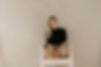 This is a female photographer sitting in a chair at a photo studio