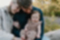This family of three is sitting on a log near Mt. Bachelor during a family photography session.