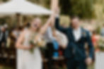 This is a bride and groom cheering and smiling at the camera after their wedding ceremony in Bend, Oregon.