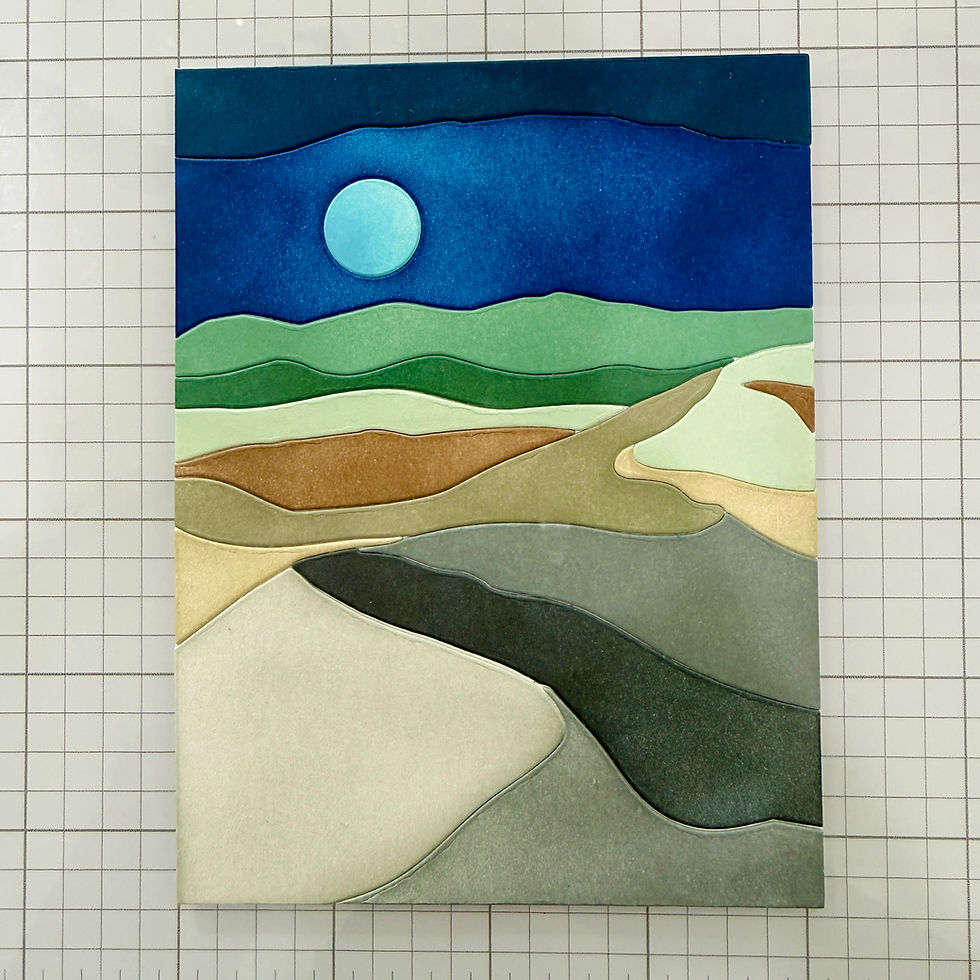 Abstract layered paper landscape with blue sky, pale moon, and green-tan hills on graph paper.