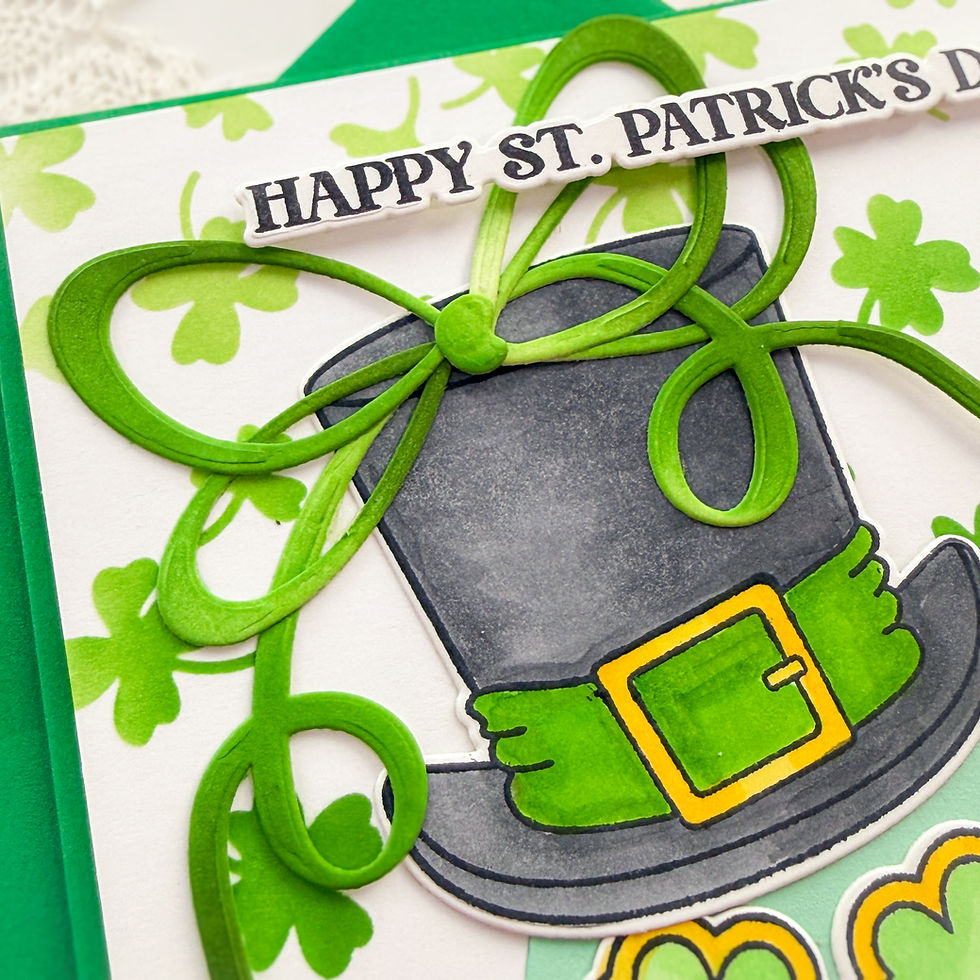St. Patrick's Day card with a black top hat, green shamrocks, and a green bow. "Happy St. Patrick's Day" text in bold. Festive mood.