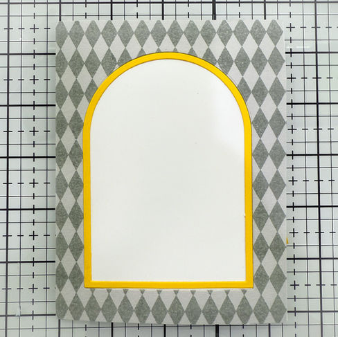 Pepita background and yellow frame on white card base.