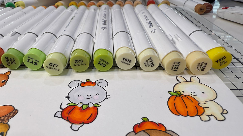 Markers labeled with color names like "Sugarcane" and "Primrose" on a table. Cute illustrations of a mouse and a bunny with pumpkins below.