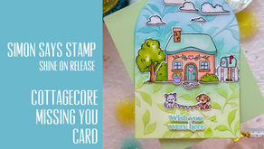 Pastel handmade cottage card with house, clouds, pets, and Wish you were here text; Simon Says Stamp release graphic.
