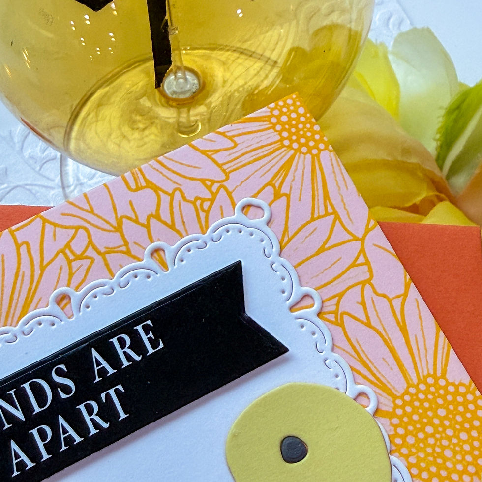 Yellow light bulb above floral cards with text "FRIENDS ARE APART", set against a background of yellow and orange tones.