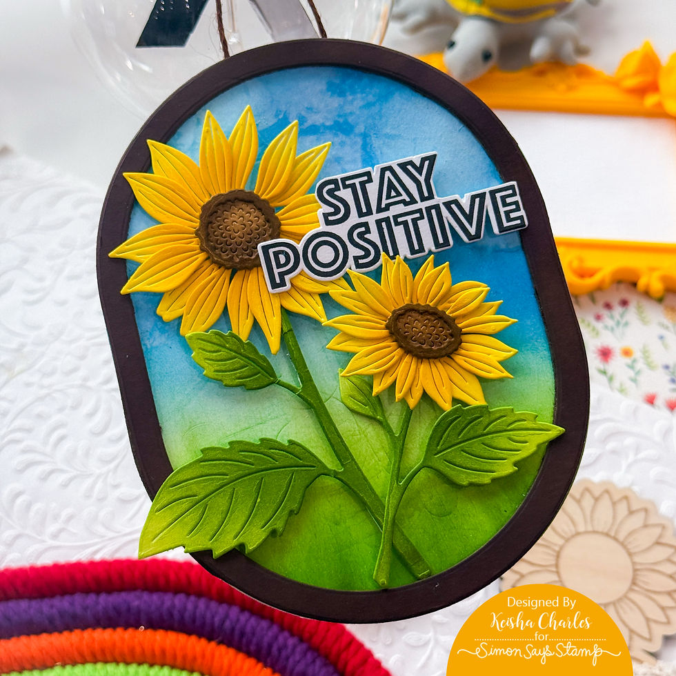Handmade sunflower card with Stay Positive text on blue sky background, bright yellow flowers and green leaves.