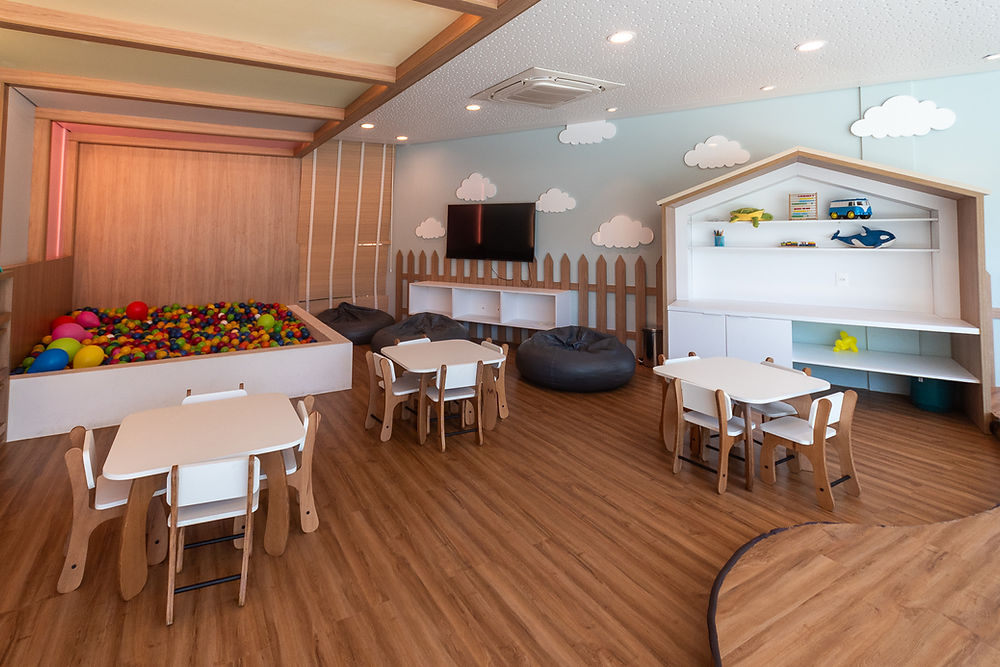 Bright children's play area with ball pit, tables, and toys