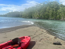 Kayak on riverbank at retreat location.