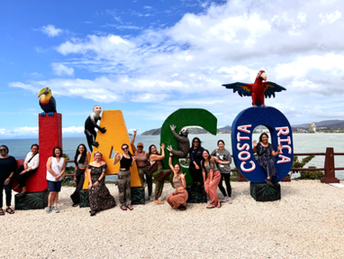 Retreat group posing at colorful landmark.