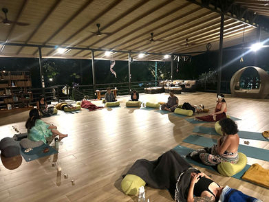 Group SOMA Breath session in open-air pavilion at night.