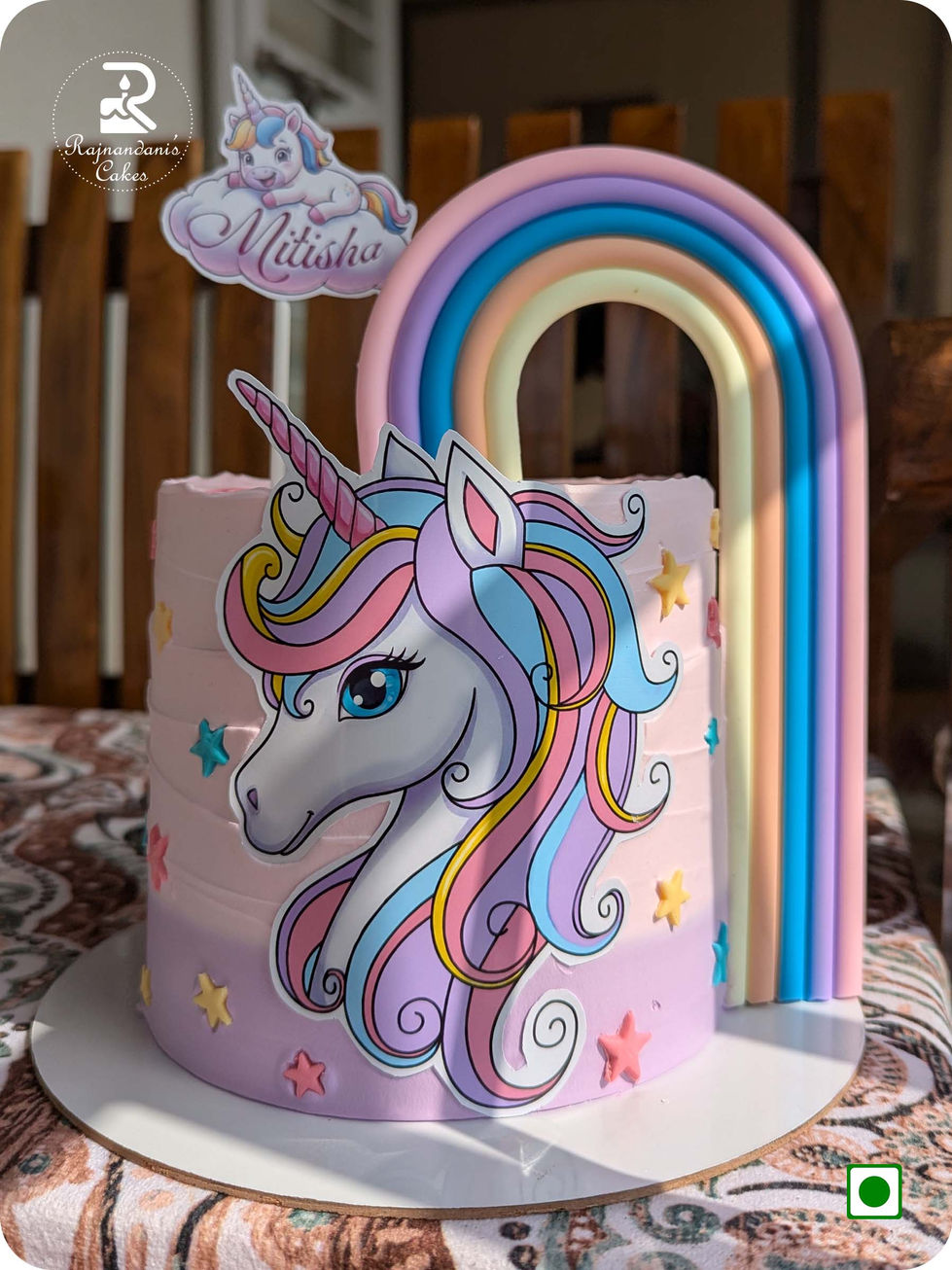Magical pastel rainbow unicorn theme birthday cake crafted by Rajnandani's Cakes for kids' special celebrations.