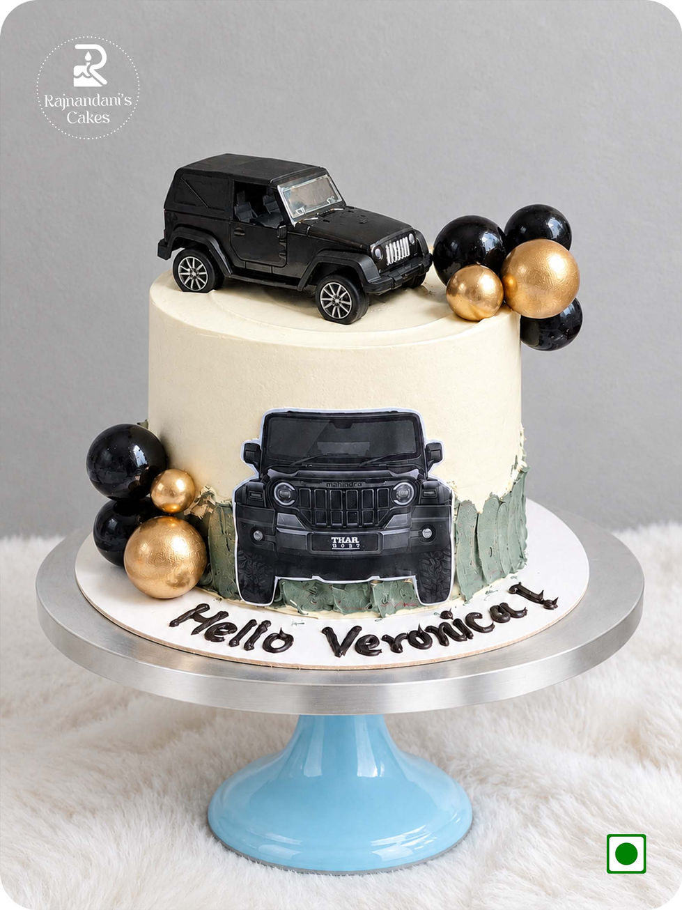 Custom Mahindra Thar off-road vehicle cake with black and gold spheres by Rajnandani's Cakes.