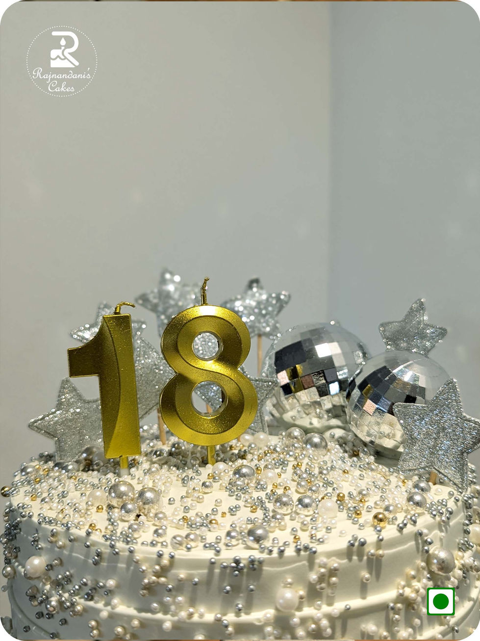 Custom 18th birthday disco theme cake with gold candles, silver star toppers, and pearl sprinkles by Rajnandani's Cakes.