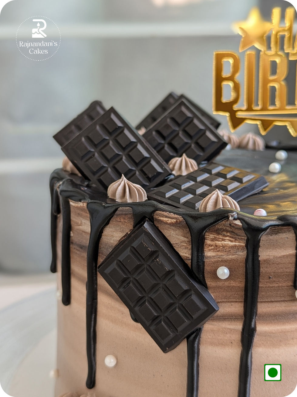 Brown gradient cake with rich chocolate drip, mini chocolate slabs, and edible pearls by Rajnandani's Cakes.
