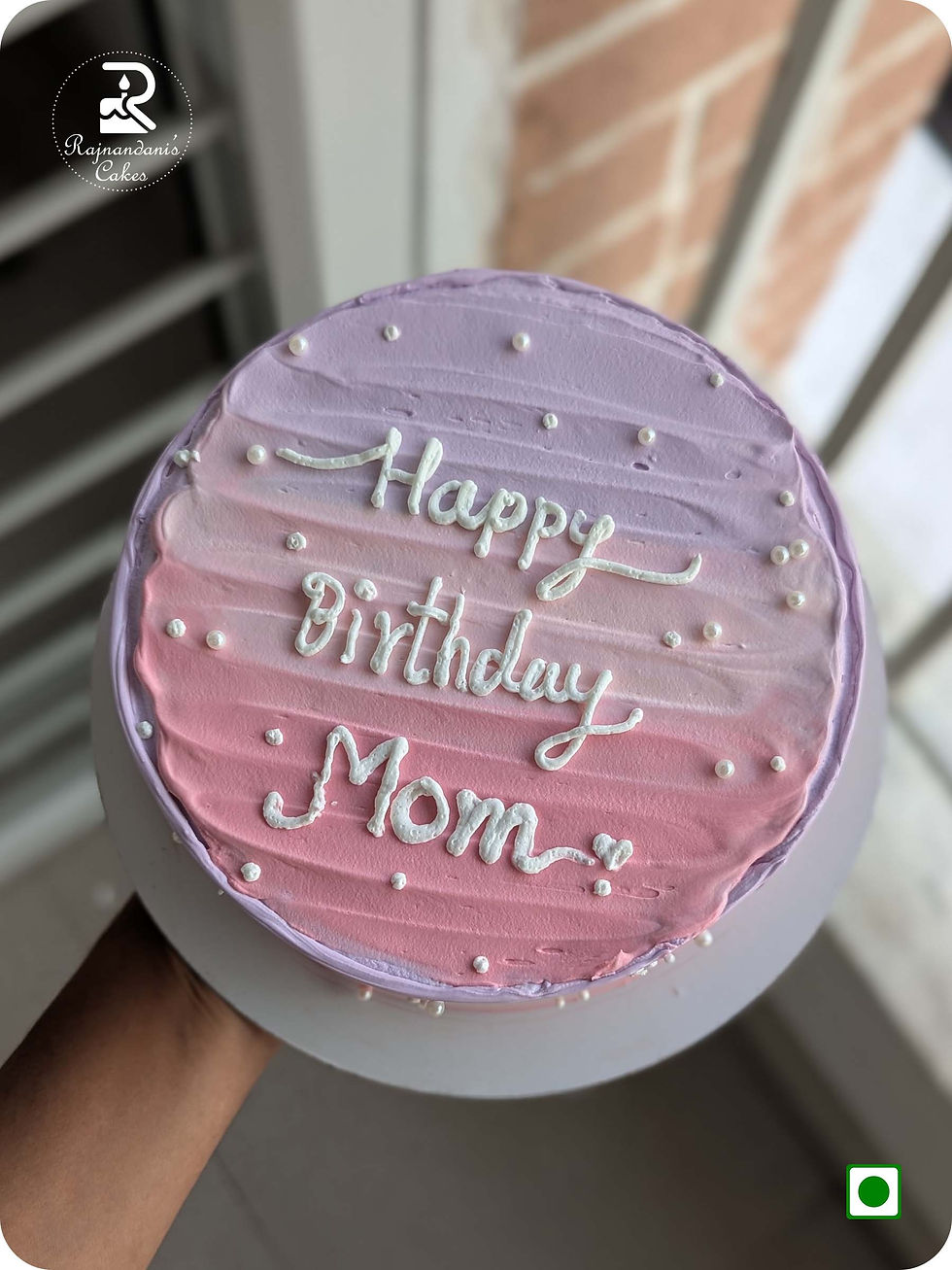 Delicate pink and purple ombre birthday cake for mom detailed with classic white piping and scattered pearl beads.
