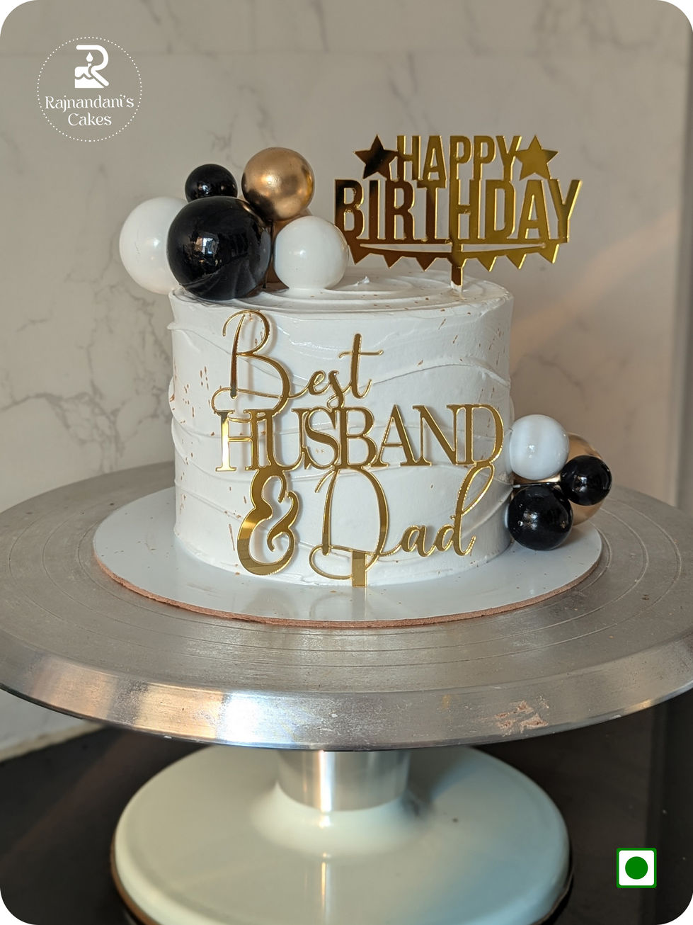 Textured cake featuring Best Husband and Dad toppers with modern decorative spheres by Rajnandani's Cakes.